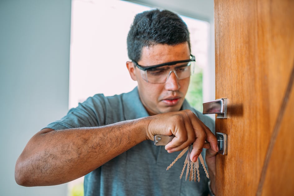 locksmith-opening-door-male-hands-repair-installing-metal-door-lock-with-screwdriver