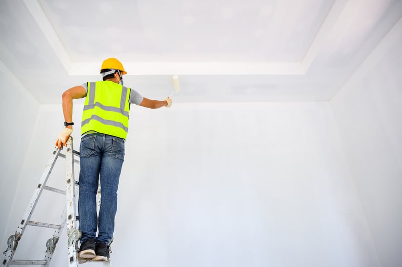 young-asian-worker-paint-ceiling-inside-house-use-roller-paint-white-primer-construction-site
